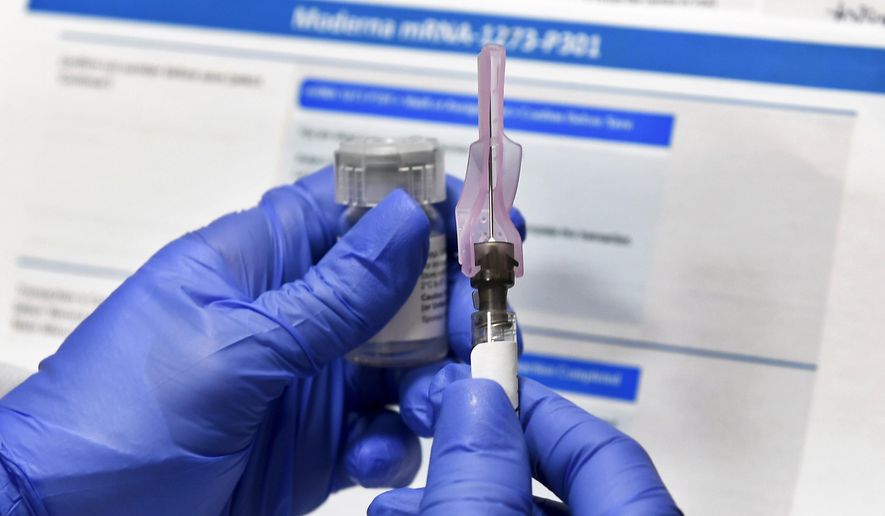 In this Monday, July 27, 2020, photo, a nurse prepares a shot as a study of a possible COVID-19 vaccine, developed by the National Institutes of Health and Moderna Inc., gets underway in Binghamton, N.Y. On Sept. 4, 2020, President Trump said he was looking forward to preliminary numbers from a vaccine trial coming out in late October. (AP Photo/Hans Pennink) **FILE**