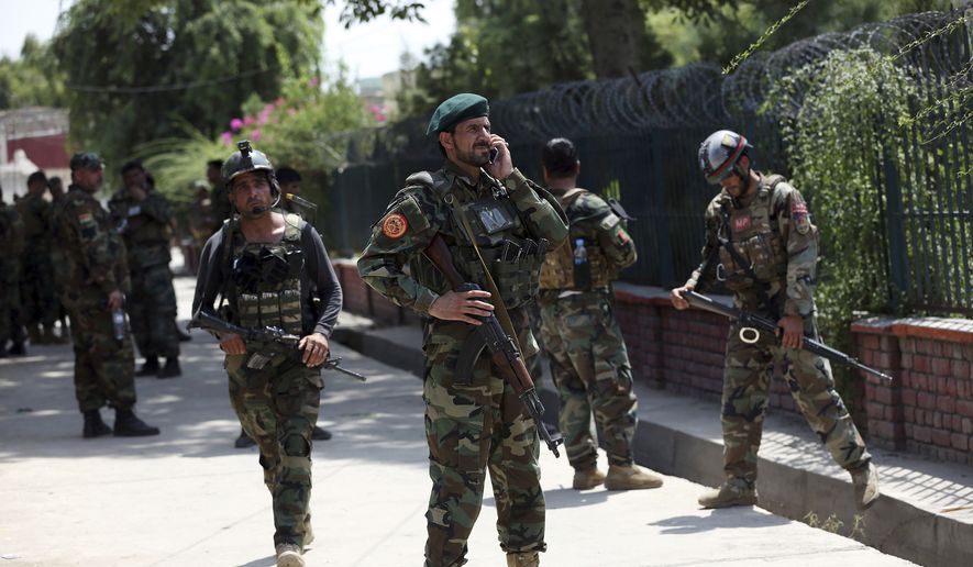 Afghan security personnel gather near a prison after an attack in the city of Jalalabad, east of Kabul, Afghanistan, Monday, Aug. 3, 2020. An Islamic State group attack on the prison in eastern Afghanistan holding hundreds of its members raged on Monday after killing people in fighting overnight, a local official said. (AP Photo/Rahmat Gul)