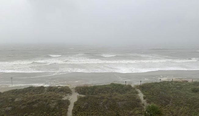 Bands of wind and rain from Hurricane Isaias make it to North Myrtle Beach, S. C., Monday, Aug. 3, 2020. The storm is expected to make landfall along the Carolina coast late Monday evening. (AP Photo/Sarah Blake Morgan)