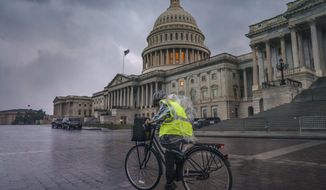 Dark clouds and heavy rain sweep over the U.S. Capitol in Washington, Monday, Aug. 3, 2020, as Tropical Storm Isaias pushes toward the Mid-Atlantic. (AP Photo/J. Scott Applewhite)