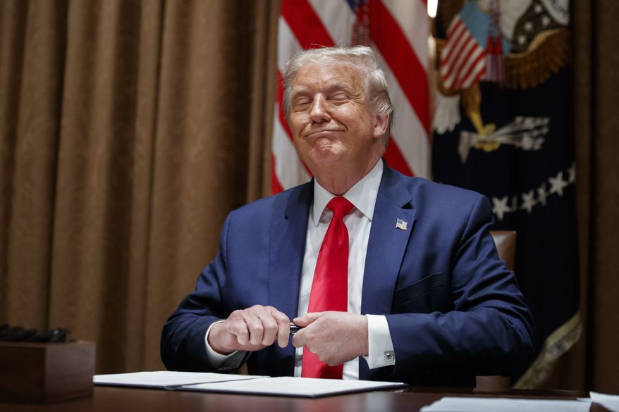 President Donald Trump prepares to sign an Executive Order on hiring American workers, in the Cabinet Room of the White House, Monday, Aug. 3, 2020, in Washington. (AP Photo/Alex Brandon)