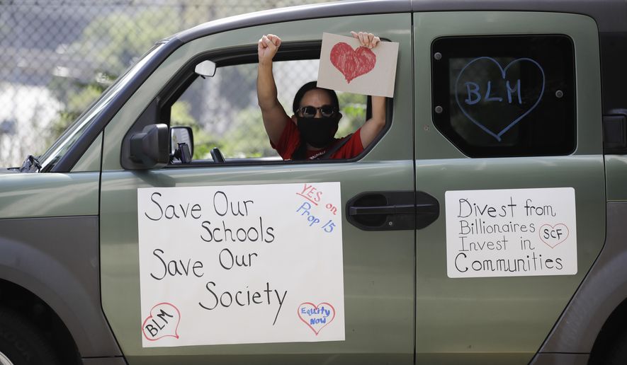 Demonstrators participate in a car caravan Monday, Aug. 3, 2020, in Los Angeles. Parents, students, and teachers held a press conference and car caravan to call for a safe, fully funded, and racially just approach to reopening of Los Angeles schools. (AP Photo/Marcio Jose Sanchez)