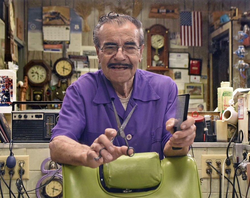 Barber Allen Wanner poses for a photo on Tuesday, July 28, 2020, after he celebrated his 90th birthday on Monday, in Mandan, N.D. His DeLuxe Barber Shop in Mandan is open Tuesday through Saturday, the same hours he’s kept since becoming a barber in 1956. Turning 90 doesn’t mean retirement. (Tom Stromme/The Bismarck Tribune via AP)