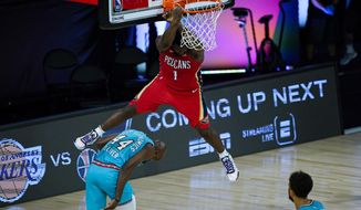 New Orleans Pelicans&#39; Zion Williamson (1) comes down after a dunk over Memphis Grizzlies&#39; Anthony Tolliver (44) during the first half of an NBA basketball game Monday, Aug. 3, 2020 in Lake Buena Vista, Fla. (AP Photo/Ashley Landis, Pool)