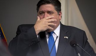 Illinois Governor JB Pritzker motions that people sometimes forget to wear their mask even when they have it their pocket as he answers questions from the media after he unveiled a new mask awareness campaign called &amp;quot;It Only Works If You Wear It&amp;quot; during a press conference at the IEMA State Emergency Operations Center, Monday, August 3, 2020, in Springfield, Ill.  (Justin L. Fowler/The State Journal-Register via AP)