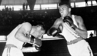 FILE - In this Sept. 3, 1960, file photo, Cassius Clay, 18-year-old from Louisville, Ky., throws a right at Tony Madigan of Australia, left, during the light heavyweight boxing semi-finals at the Summer Olympic Games in Rome. The 1960 Rome Summer Olympics set the standard for every Olympiad to follow. These Games were the first televised in the United States (AP Photo/File)