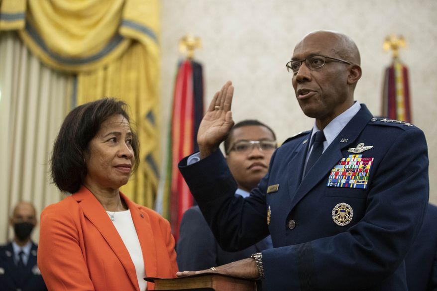 Gen. Charles Q. Brown Jr., is sworn is as Chief of Staff of the Air Force as his wife Sharene Guilford Brown, holds a bible, in the Oval Office of the White House, Tuesday, Aug. 4, 2020, in Washington. (AP Photo/Alex Brandon)