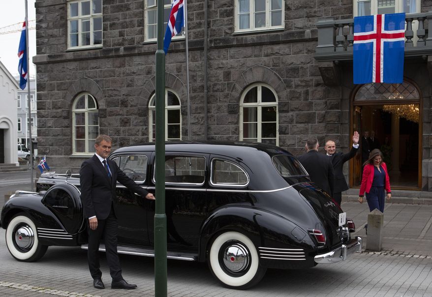 Iceland's President Guðni Th. Jóhannesson waves as he gets into a car following his inauguration in Reykjavik, Iceland Saturday, Aug. 1, 2020. In Iceland, a nation so safe that its president runs errands on a bicycle, U.S. Ambassador Jeffery Ross Gunter has left locals aghast with his request to hire armed bodyguards. He's also enraged lawmakers by casually and groundlessly hitching Iceland to President Donald Trump's controversial "China virus” label for the coronavirus. (AP Photo/Árni Torfason)