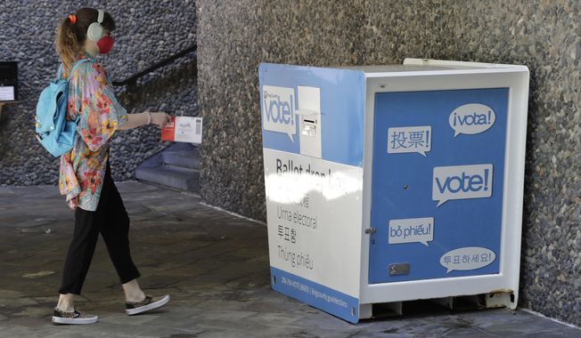 A person drops off a ballot for Washington state&#x27;s primary election, Tuesday, Aug. 4, 2020, at a collection box at the King County Administration Building in Seattle. Voters in the state have the option of voting by mail, depositing ballots in boxes, or seeking help in person for a missing ballot or other issues. (AP Photo/Ted S. Warren)