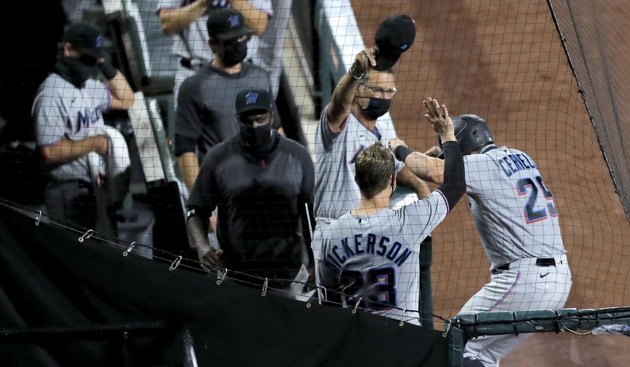 Miami Marlins' Francisco Cervelli, right, reacts while celebrating near his team's dugout after hitting a solo home run off Baltimore Orioles starting pitcher John Means during the fifth inning of a baseball game, Tuesday, Aug. 4, 2020, in Baltimore. (AP Photo/Julio Cortez)
