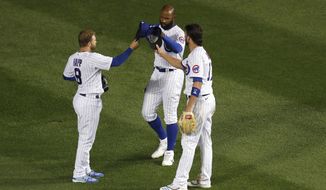 Chicago Cubs outfielders Ian Happ, Jason Heyward and Kris Bryant, from left, celebrate the team&#39;s 2-0 win over the Kansas City Royals in a baseball game Monday, Aug. 3, 2020, in Chicago. (AP Photo/Charles Rex Arbogast)