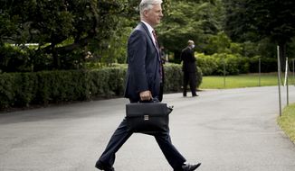 FILE - In this July 10, 2020, file photo White House national security adviser Robert O&#39;Brien walks South Lawn of the White House in Washington. O&#39;Brien who tested positive for the coronavirus, returned to work on Tuesday, Aug. 4, after recovering from a mild case of COVID-19, the White House said. (AP Photo/Andrew Harnik, File)