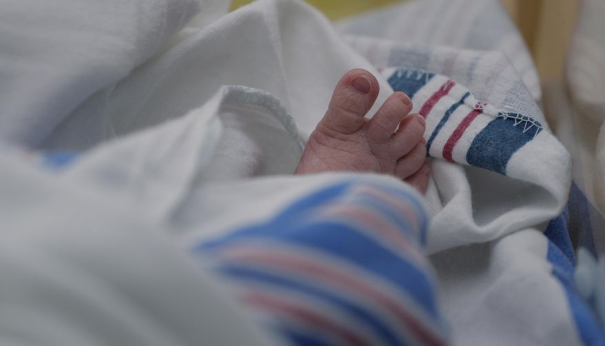 The toes of a baby born to a mom with COVID-19 are seen at DHR Health, Wednesday, July 29, 2020, in McAllen, Texas. The hospital lets COVID-positive mothers call the nursery over a video chat. (AP Photo/Eric Gay) ** FILE **