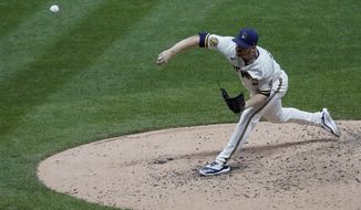 Milwaukee Brewers starting pitcher Brandon Woodruff throws during the fourth inning of a baseball game against the Chicago White Sox Tuesday, Aug. 4, 2020, in Milwaukee. (AP Photo/Morry Gash)