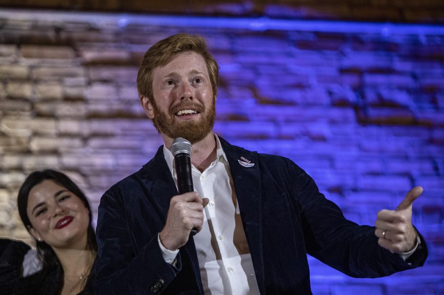 Peter Meijer declares victory in the 3rd Congressional District Republican primary, next to his wife, Gabriella Meijer, in Grand Rapids, Mich., Tuesday, Aug. 4, 2020. Meijer will face Democrat Hillary Scholten in the general election. (Cory Morse/The Grand Rapids Press via AP)