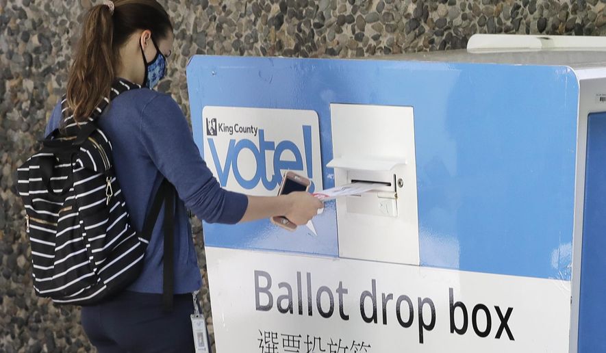 A person drops off a ballot for Washington state's primary election, Tuesday, Aug. 4, 2020, at a collection box at the King County Administration Building in Seattle. Voters in the state have the option of voting by mail, depositing ballots in boxes, or seeking help in person for a missing ballot or other issues. (AP Photo/Ted S. Warren)