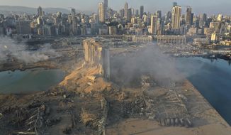 A drone picture shows the scene of an explosion at the seaport of Beirut, Lebanon, Wednesday, Aug. 5, 2020. A massive explosion rocked Beirut on Tuesday, flattening much of the city&#39;s port, damaging buildings across the capital and sending a giant mushroom cloud into the sky. More than 70 people were killed and 3,000 injured, with bodies buried in the rubble, officials said. (AP Photo/Hussein Malla)