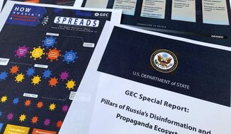 Pages from the U.S. State Department&#39;s Global Engagement Center report released on Aug. 5, 2020, are seen in this photo. The State Department says Russia is using a well-developed online operation that includes a loose collection of proxy websites to stir up confusion around the coronavirus by amplifying conspiracy theories and misinformation. The department detailed a Russian-backed misinformation cycle that spreads false information online through state officials and state-funded media reports, by infiltrating U.S. social media conversation, and leveraging a deceptive internet framework of websites. (AP Photo/Jon Elswick) **FILE**