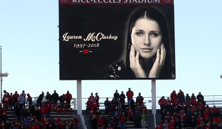 FILE - In this Nov. 10, 2018, file photo, a photograph of University of Utah student and track athlete Lauren McCluskey, who was fatally shot on campus, is projected on the video board before the start of an NCAA college football game between Oregon and Utah in Salt Lake City. An investigation found Wednesday, Aug. 5, 2020, that a group of University of Utah police officers made inappropriate comments about explicit photos of McCluskey, who had submitted the pictures as evidence in an extortion case shortly before her shooting death. The findings came after the Salt Lake Tribune unearthed allegations that an officer had bragged about having the images of McCluskey before her 2018 slaying. (AP Photo/Rick Bowmer, File)