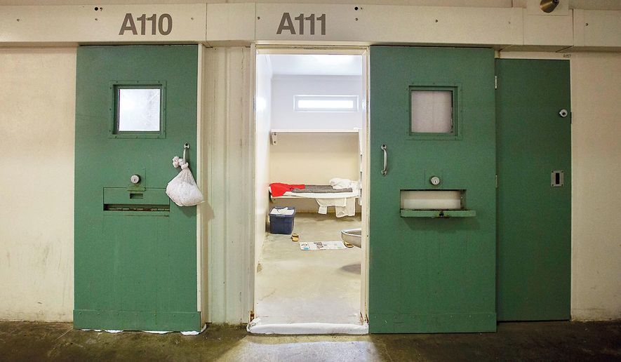 FILE - This Sept. 2, 2015 file photo shows the the door to the cell at Hampton Roads Regional Jail in Portsmouth, Va., where 24-year-old Jamycheal Mitchell was found dead Aug. 19, 2015. The Justice Department has proposed that a Virginia jail comply with a consent decree that would require officials to improve medical treatment for inmates. The announcement on Wednesday, Aug. 5, 2020, marks one of the first times the department has proposed such a resolution in the Trump administration.(Bill Tiernan/The Virginian-Pilot via AP, File)