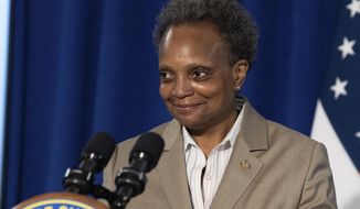 Chicago Mayor Lori Lightfoot smiles as she walks to the podium to answer questions about Chicago Public Schools&#39; plans for remote learning in the fall during a press conference at City Hall Wednesday morning August 5, 2020.(Pat Nabong/Chicago Sun-Times via AP)