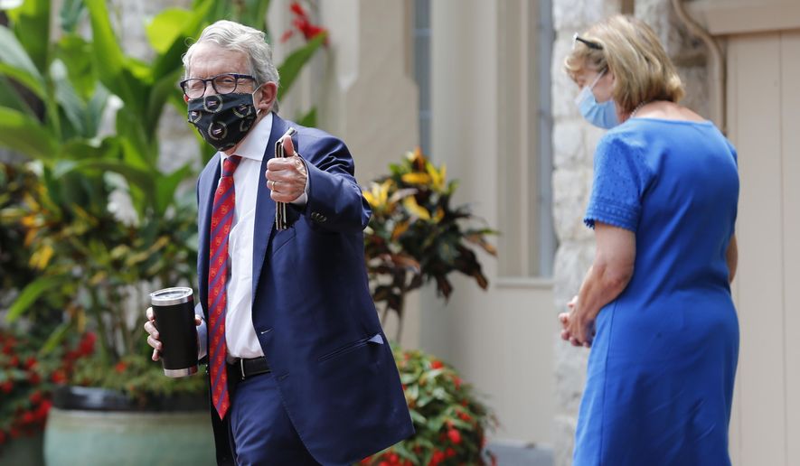 Ohio Governor Mike DeWine, left, and his wife Fran, walk into their residence after he tested positive for COVID-19 earlier in the day Thursday, Aug. 6, 2020, in Bexley, Ohio. (AP Photo/Jay LaPrete)