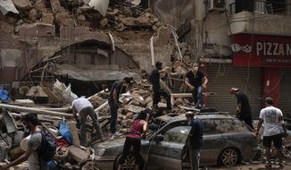 People remove debris from a house damaged by Tuesday&#39;s explosion in the seaport of Beirut, Lebanon, Friday, Aug. 7, 2020.  Rescue teams were still searching the rubble of Beirut&#39;s port for bodies on Friday, nearly three days after the massive explosion sent a wave of destruction through Lebanon&#39;s capital.   (AP Photo/Felipe Dana)