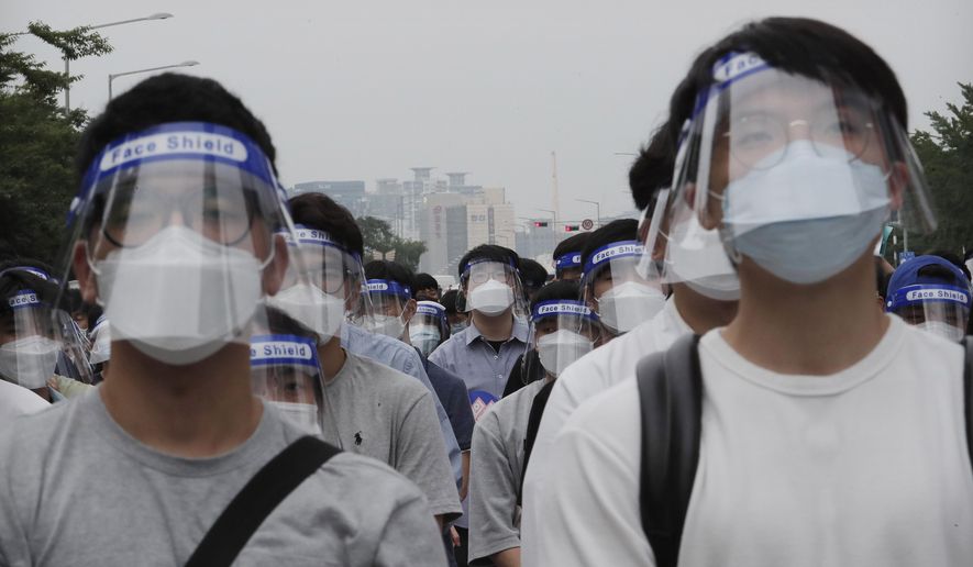 Interns and resident doctors attend a rally against the government medical policy in Seoul, South Korea, Friday, Aug. 7, 2020. Thousands of young doctors in South Korea began a strike Friday in protest of government medical policy, causing concerns about treatment of patients amid the coronavirus pandemic. (AP Photo/Ahn Young-joon)