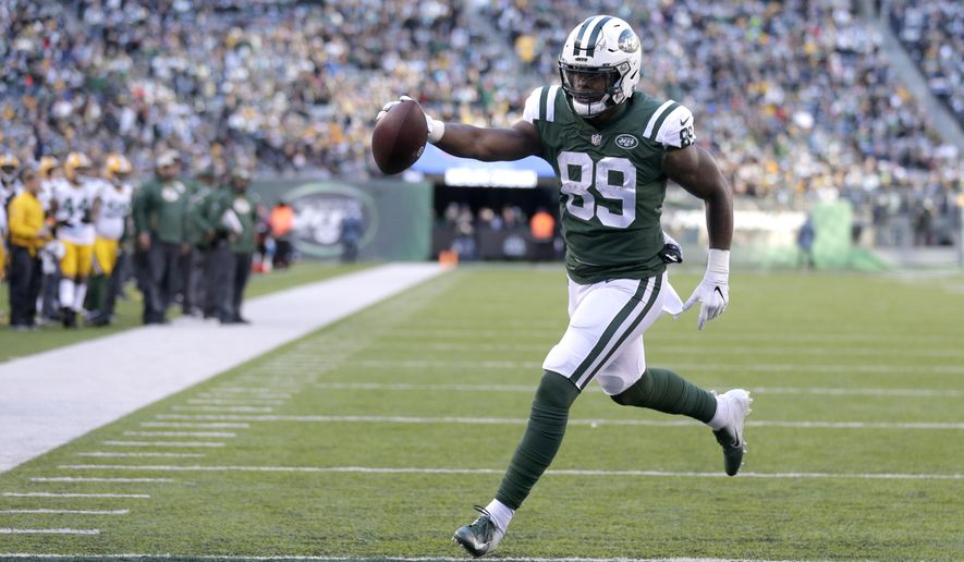 FILE - In this Dec. 23, 2018, file photo, New York Jets tight end Chris Herndon scores on a touchdown pass from quarterback Sam Darnold during the second half of an NFL football game against the Green Bay Packers in East Rutherford, N.J. Herndon was all set for a big breakout season a year ago with the Jets. A four-game suspension and a few tough injuries put those plans on hold. Now, the third-year tight end is ready to make up for lost time. (AP Photo/Seth Wenig, File)