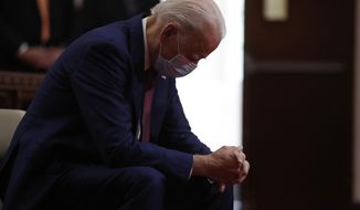 In this  June 1, 2020, file photo, Democratic presidential candidate, former Vice President Joe Biden bows his head in prayer as he visits Bethel AME Church in Wilmington, Del. Photos in a campaign ad for President Donald Trump show that former Vice President Biden is “alone, hiding, diminished.” The ad blurs details that show Biden is praying in a church. The ad was tweeted by @TeamTrump on Wednesday, Aug. 5, 2020. (AP Photo/Andrew Harnik, File)