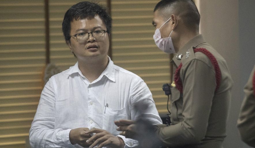 Pro-democracy activist and human rights lawyer Arnon Nampha talks to police at a police station, Friday, Aug, 7, 2020, in Bangkok, Thailand. The government cracked down on Friday with the arrests of some high profile members of the pro-democracy movement. Among them was Arnon, who was arrested on charges of sedition and defying an emergency decree the government instituted months ago to try to control the spread of the coronavirus. (AP Photo/Sakchai Lalit)