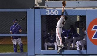 San Francisco Giants left fielder Darin Ruf can&#39;t reach a ball hit for a two-run home run by Los Angeles Dodgers&#39; Will Smith during the fourth inning of a baseball game Friday, Aug. 7, 2020, in Los Angeles. (AP Photo/Mark J. Terrill)
