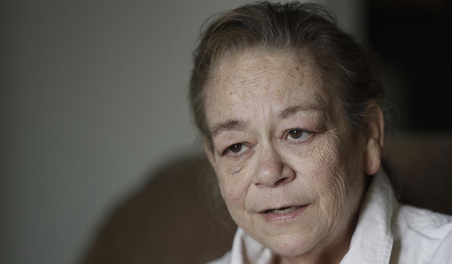 Leesa Huddleston talks about washing dishes and cleaning kitchens at a casino from her home, Monday, Aug. 3, 2020, in Shelbyville, Ind.  Huddleston returned in June after a three-month furlough caused by the coronavirus. She felt fortunate to no longer be among the roughly 30 million Americans who remain jobless and are now struggling with suddenly reduced unemployment aid. Yet the return of her job hardly ended Huddleston's financial troubles. Her employer, its revenue shrunken by the loss of customers, cut her schedule to four days a week. (AP Photo/Darron Cummings)