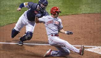 Milwaukee Brewers catcher Omar Narvaez tags out Cincinnati Reds&#39; Shogo Akiyama at home during the seventh inning of a baseball game Saturday, Aug. 8, 2020, in Milwaukee. Akiyama tried to score from third on a ball hit by Joey Votto. (AP Photo/Morry Gash)
