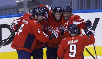 Washington Capitals left wing Alex Ovechkin (8), right wing T.J. Oshie (77), center Nicklas Backstrom (19), defenseman Brenden Dillon (4) and defenseman Dmitry Orlov (9) celebrate Oshie&#39;s goal against the Boston Bruins during first-period NHL Stanley Cup qualifying round game action in Toronto, Sunday, Aug. 9, 2020. (Cole Burston/The Canadian Press via AP)