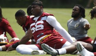 Washington linebacker Reuben Foster stretches during a practice at the team&#39;s NFL football practice facility, in a Reuben Foster Monday, May 20, 2019 file photo, in Ashburn, Va.The Washington Football Team activated linebacker Reuben Foster off the physically unable to perform list Sunday, Aug.9, 2020. The team made the move days ahead of the start of on-field training camp workouts.   (AP Photo/Patrick Semansky, File)