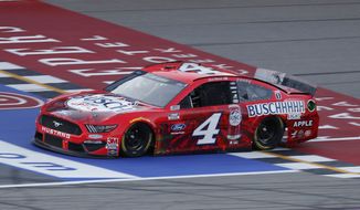 Kevin Harvick crosses the finish line to win the NASCAR Cup Series auto race at Michigan International Speedway in Brooklyn, Mich., Sunday, Aug. 9, 2020. (AP Photo/Paul Sancya)