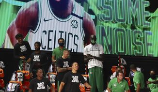 Boston Celtics bench reacts after guard Jaylen Brown (not pictured) makes a basket against the Orlando Magic during the first half of an NBA basketball game Sunday, Aug. 9, 2020, in Lake Buena Vista, Fla. (Kim Klement/Pool Photo via AP)
