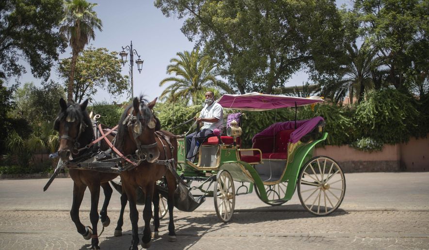 Mohammed El Garbouh, a horse carriage owner, waits for customers in the landmark Jemma el-Fnaa in Marrakech, Morocco, Wednesday, July 22, 2020. Morocco&#x27;s restrictions to counter the coronavirus pandemic have taken a toll on the carriage horses in the tourist mecca of Marrakech. Some owners struggle to feed them, and an animal protection group says hundreds of Morocco&#x27;s horses and donkeys face starvation amid the collapsing tourism industry. (AP Photo/Mosa&#x27;ab Elshamy)