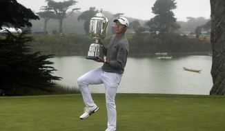 Collin Morikawa holds the Wanamaker Trophy after winning the PGA Championship golf tournament at TPC Harding Park Sunday, Aug. 9, 2020, in San Francisco. (AP Photo/Jeff Chiu)