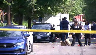 In this image from video provided by NBC4 Washington, law enforcement work the scene of a shooting, Sunday, Aug. 9, 2020, in Southeast Washington.  (NBC4 Washington via AP)