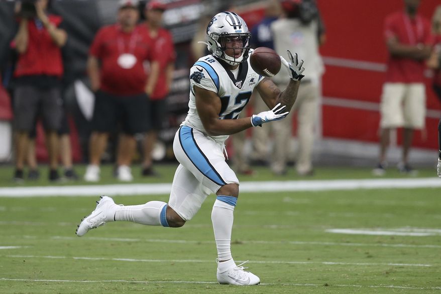  In this Sept. 22, 2019, file photo, Carolina Panthers wide receiver D.J. Moore (12) pulls in a touchdown catch against the Arizona Cardinals during the first half of an NFL football game in Glendale, Ariz. The Panthers want more out of third-year receiver D.J, Moore. Moore is coming off a solid season a year ago with 87 receptions for 1,175 receiving yards and four touchdowns, averaging 13.5 yards per catch. But the team feels he can be their No. 1 receiver.(AP Photo/Ross D. Franklin, File)  **FILE**