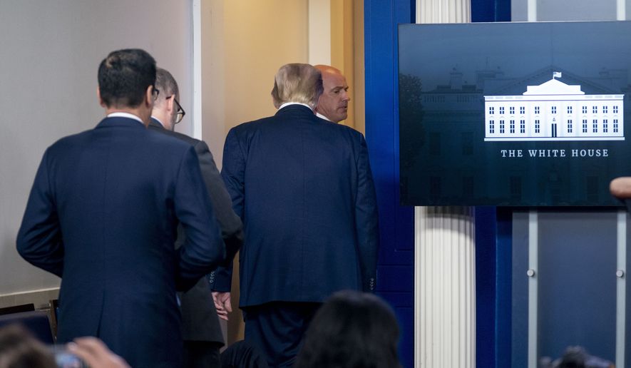President Donald Trump is asked to leave the James Brady Press Briefing Room by a member of the U.S. Secret Service during a news conference at the White House, Monday, Aug. 10, 2020. (AP Photo/Andrew Harnik)