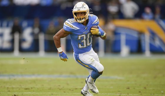 FILE - In this Dec. 22, 2019, file photo, Los Angeles Chargers running back Austin Ekeler runs against the Oakland Raiders during the second half of an NFL football game in Carson, Calif. Ekeler could be the one player who benefits the most from the Los Angeles Chargers changes on offense. (AP Photo/Kelvin Kuo, File)