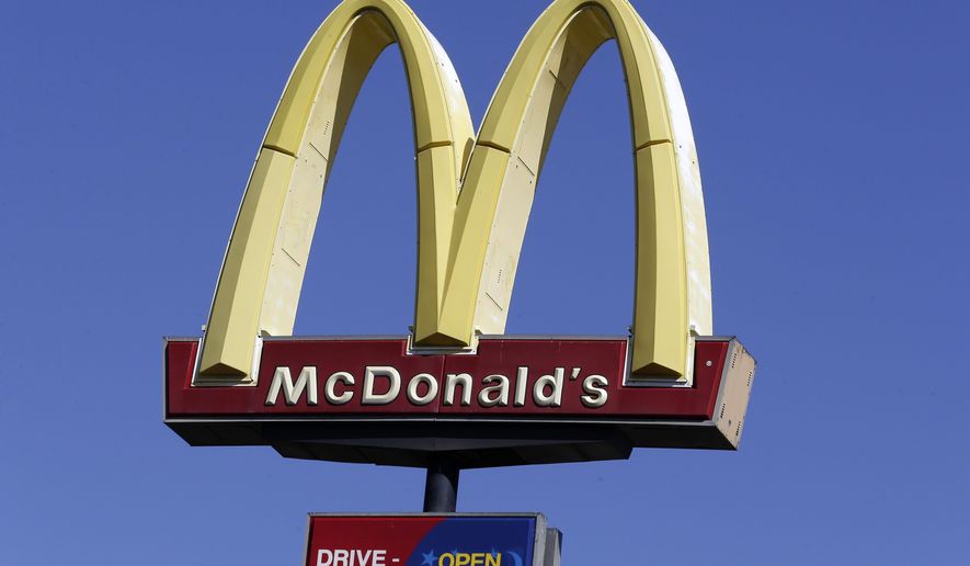 FILE - This Oct. 17, 2019 file photo shows a McDonald&#39;s sign along Interstate 40/85 in Burlington, N.C. McDonald’s sales improved throughout the second quarter, Tuesday, July 28, 2020,  as markets reopened globally, but the fast food giant still faces a bumpy recovery. (AP Photo/Gerry Broome, File)
