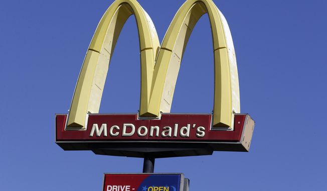 FILE - This Oct. 17, 2019 file photo shows a McDonald&#x27;s sign along Interstate 40/85 in Burlington, N.C. McDonald’s sales improved throughout the second quarter, Tuesday, July 28, 2020,  as markets reopened globally, but the fast food giant still faces a bumpy recovery. (AP Photo/Gerry Broome, File)