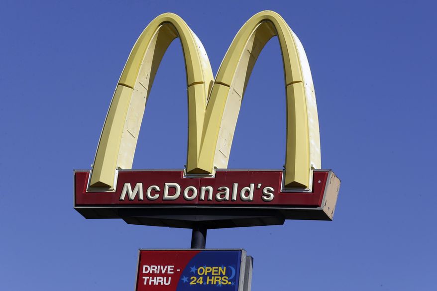 FILE - This Oct. 17, 2019 file photo shows a McDonald&#39;s sign along Interstate 40/85 in Burlington, N.C. McDonald’s sales improved throughout the second quarter, Tuesday, July 28, 2020,  as markets reopened globally, but the fast food giant still faces a bumpy recovery. (AP Photo/Gerry Broome, File)