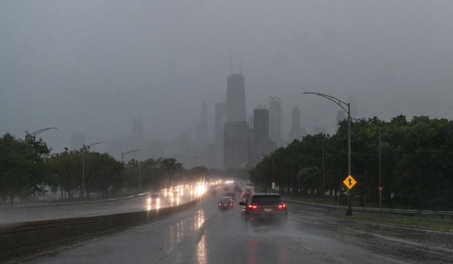 Drivers make their way along Lake Shore Drive as a severe storm moves through Chicago, Monday, Aug. 10, 2020. (Tyler LaRiviere/Chicago Sun-Times via AP)