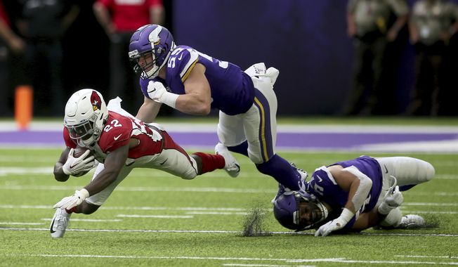 FILE - In this Aug. 24, 2019, file photo, Arizona Cardinals running back T.J. Logan (22) runs from Minnesota Vikings linebacker Cameron Smith (59) during the second half of an NFL preseason football game in Minneapolis. Smith will miss the 2020 season because of a heart condition. It was discovered after he tested positive for COVID-19 upon reporting to training camp two weeks ago. The Vikings made the procedural move on Monday, Aug. 10, 2020, of waiving Smith with a non-football injury designation. (AP Photo/Jim Mone, File)