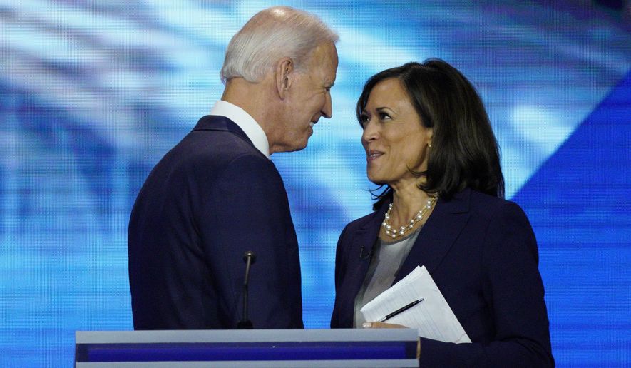 FILE - In this Sept. 12, 2019, file photo, Democratic presidential candidate former Vice President Joe Biden, left, and then-candidate Sen. Kamala Harris, D-Calif. shake hands after a Democratic presidential primary debate hosted by ABC at Texas Southern University in Houston. Biden has chosen Harris as his running mate. (AP Photo/David J. Phillip, File)